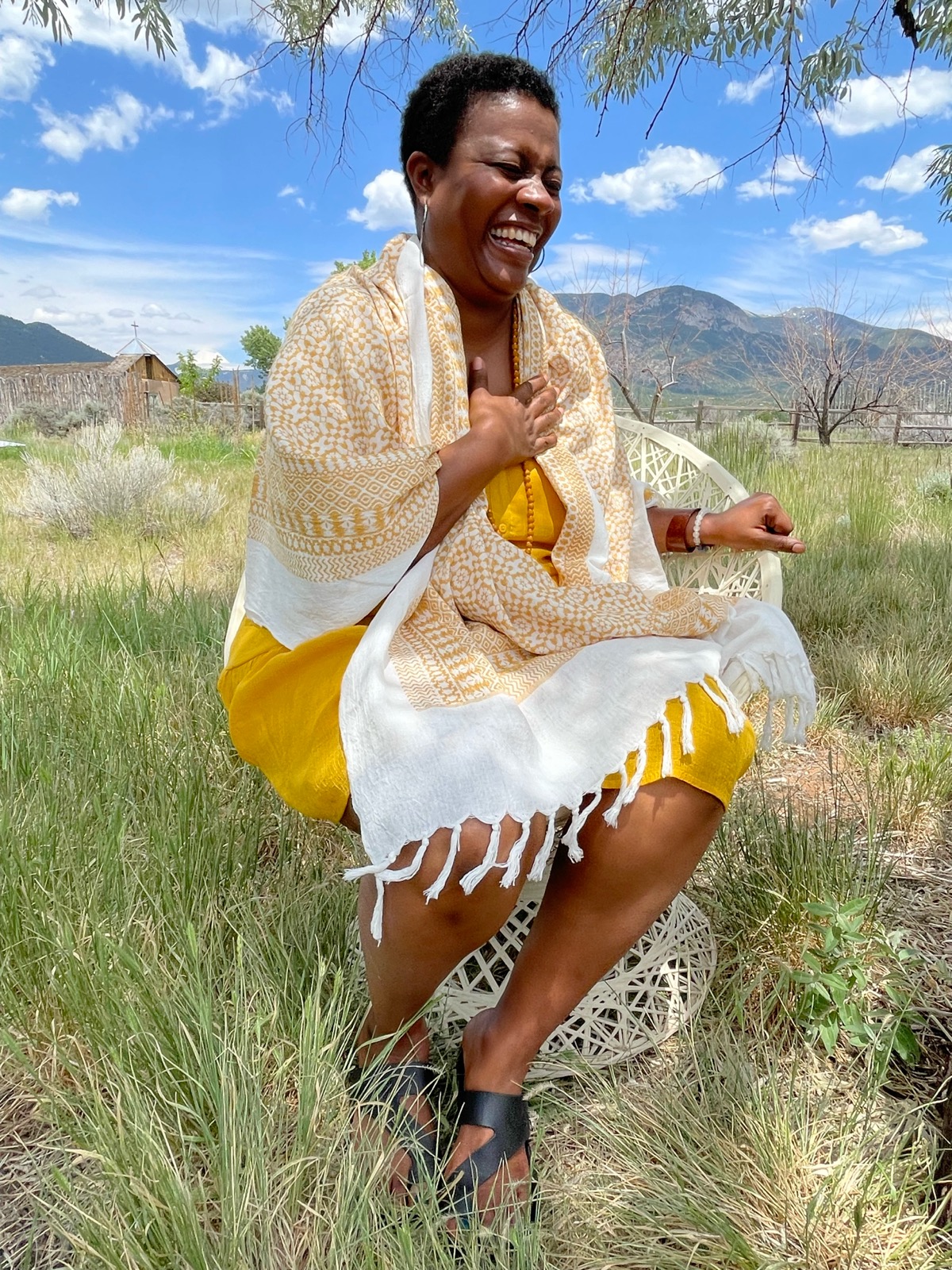 Nayma Freedom laughing in a sunlit field