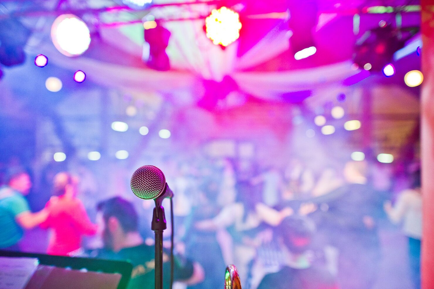 A microphone on a vibrant stage